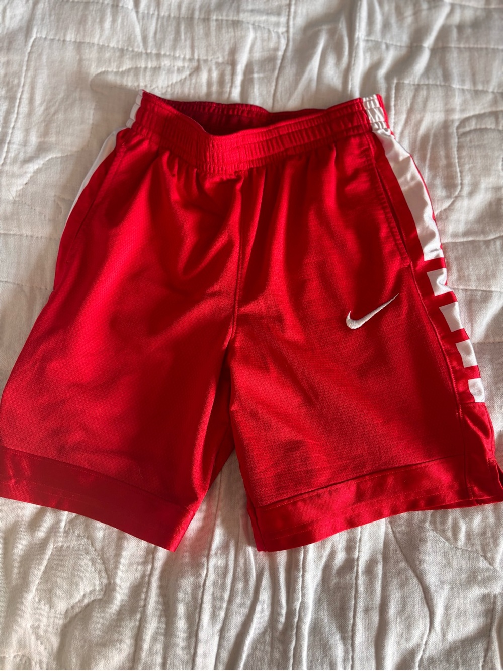 Nike YL Basketball Shorts. Red. White accents on the sides. Drawstring.